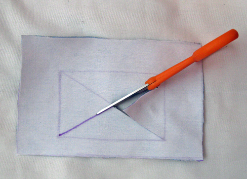Cut along the legs of the X