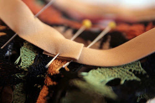 Having trouble stitching along an edge evenly? Try an edgestitch foot! Adjust the blade (or your needle position) so the blade rests on the edge and the needle is 2-3 mm to one side. Move the edge (or seam or fold) along the guide, and your stitching will be perfectly placed—so easy!