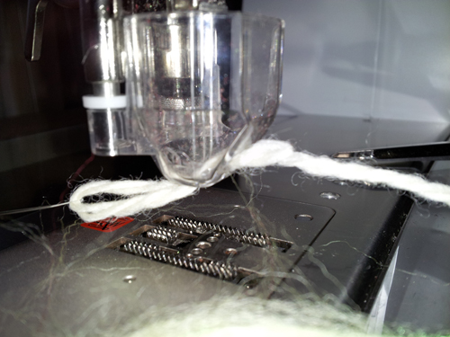 thread yarn into the needle punch guide