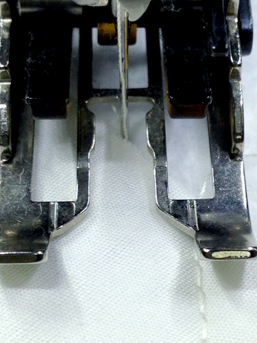 For the first line of quilting, sew 1/2" away from the last slanted stitch using your walking foot with the quilting/open sole.