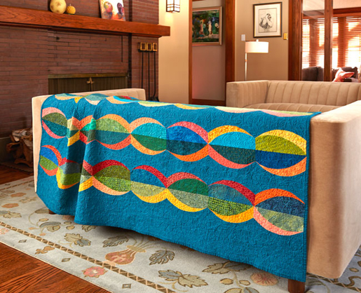 blue quilt with orange and yellow waves