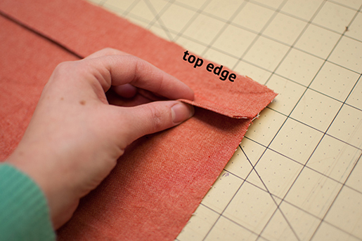 folded edge of pleated bodice