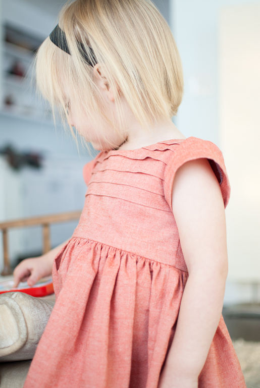 girl wearing pleated bodice dress