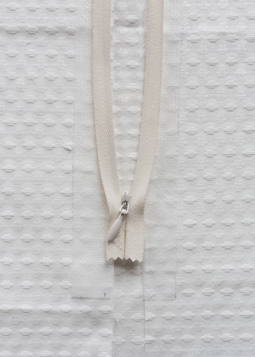 interfacing strip should be ¼" wider than the seam allowance and 1" longer than zipper opening