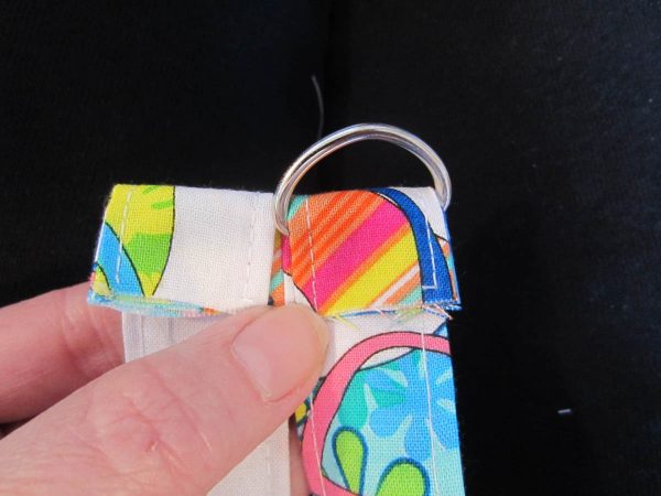 Slide remaining strap material through D-ring