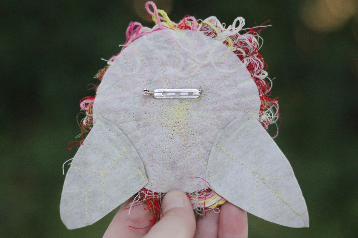 Recycled thread flower pin Step Ten: attach the pin back