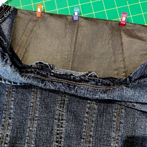 Fold the jacket, right sides together, on the horizontal marked line, clipping in place to hold. Set aside while we prepare the stabilizer.