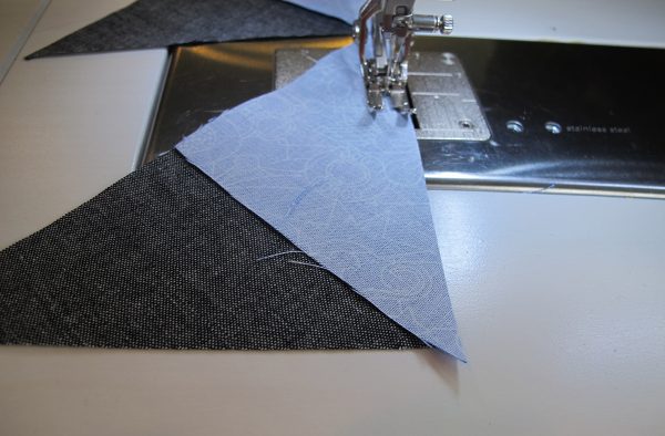 Stitch 2 Fabric C triangles to a large Fabric D triangle