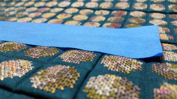 Painter's tape used to remove lint from the quilt