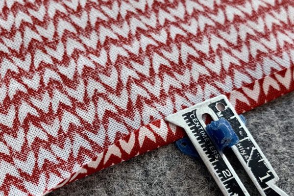 Turn another 1/4" to wrong side on ruffle and press