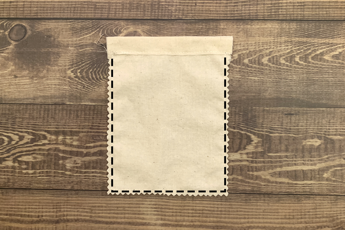Tooth Fairy Drawstring Pouch Pattern: Photo of bag in process showing stitching along the bottom and sides with a .25 inch seam allowance, trimmed with pinking shears.