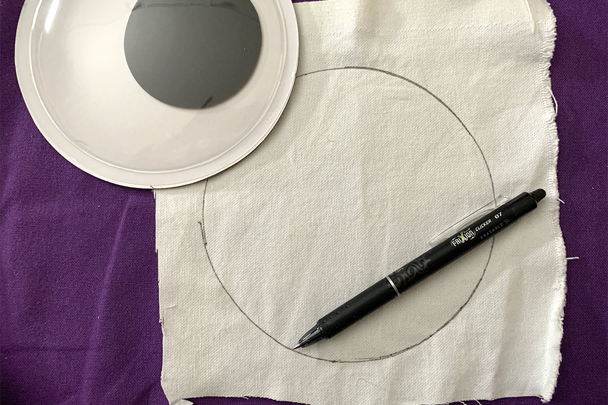 The result of tracing the googley eye onto white canvas for applique.
