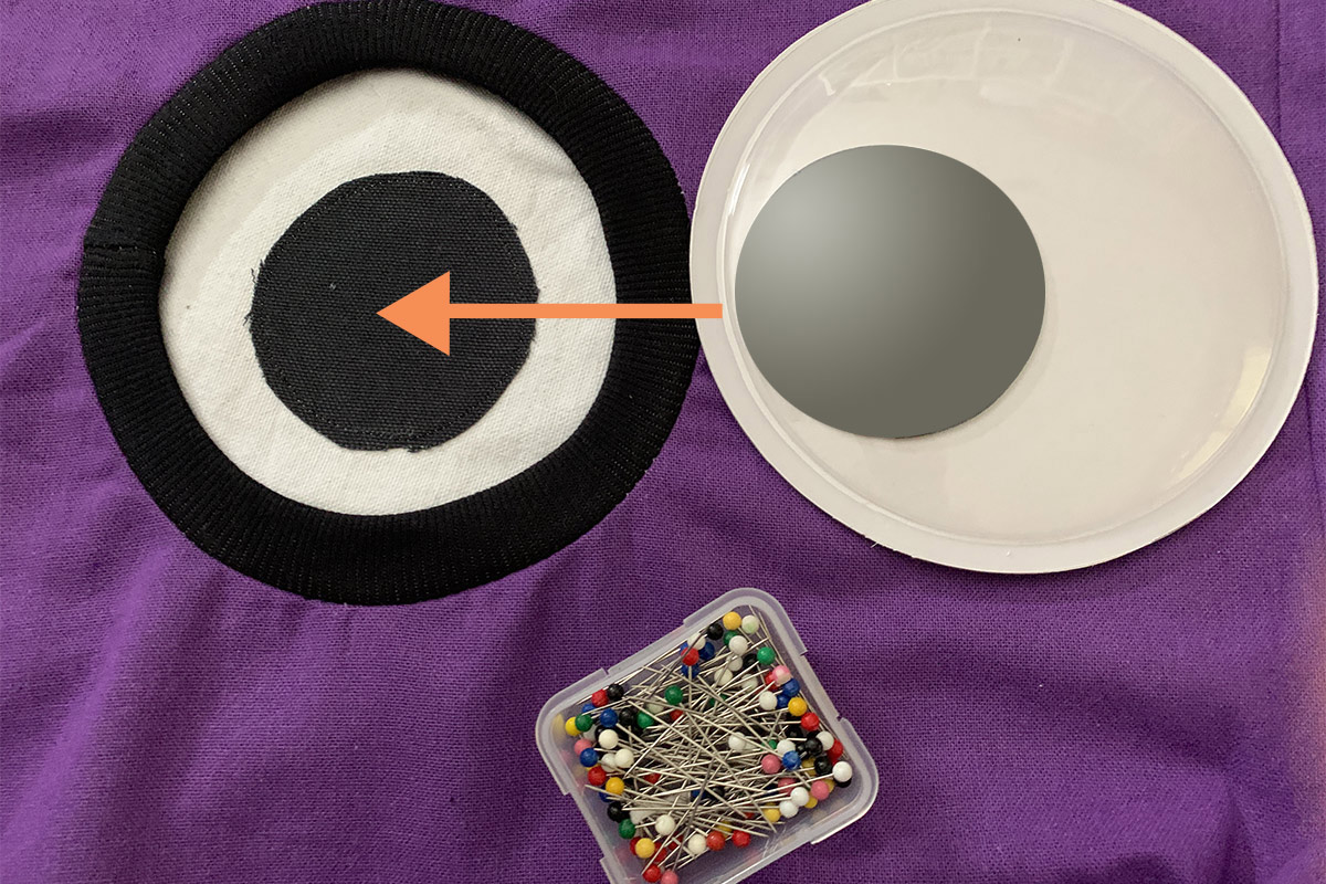 Image showing how to insert the googley eye into the socket made with ribbing.