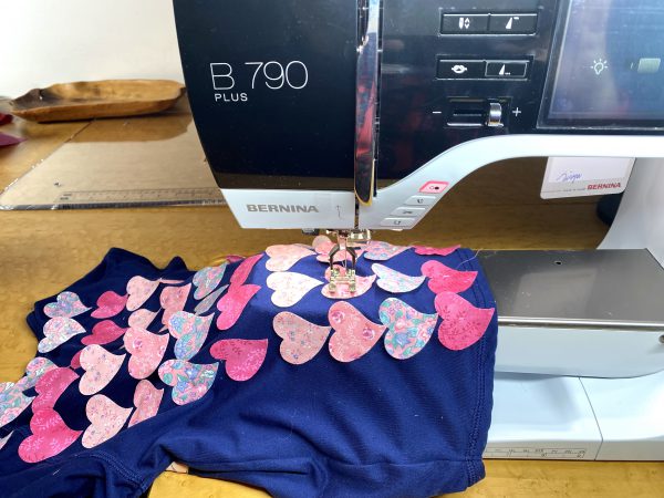 Free arm allows hearts to be stitched on shirt without stretching or pulling.