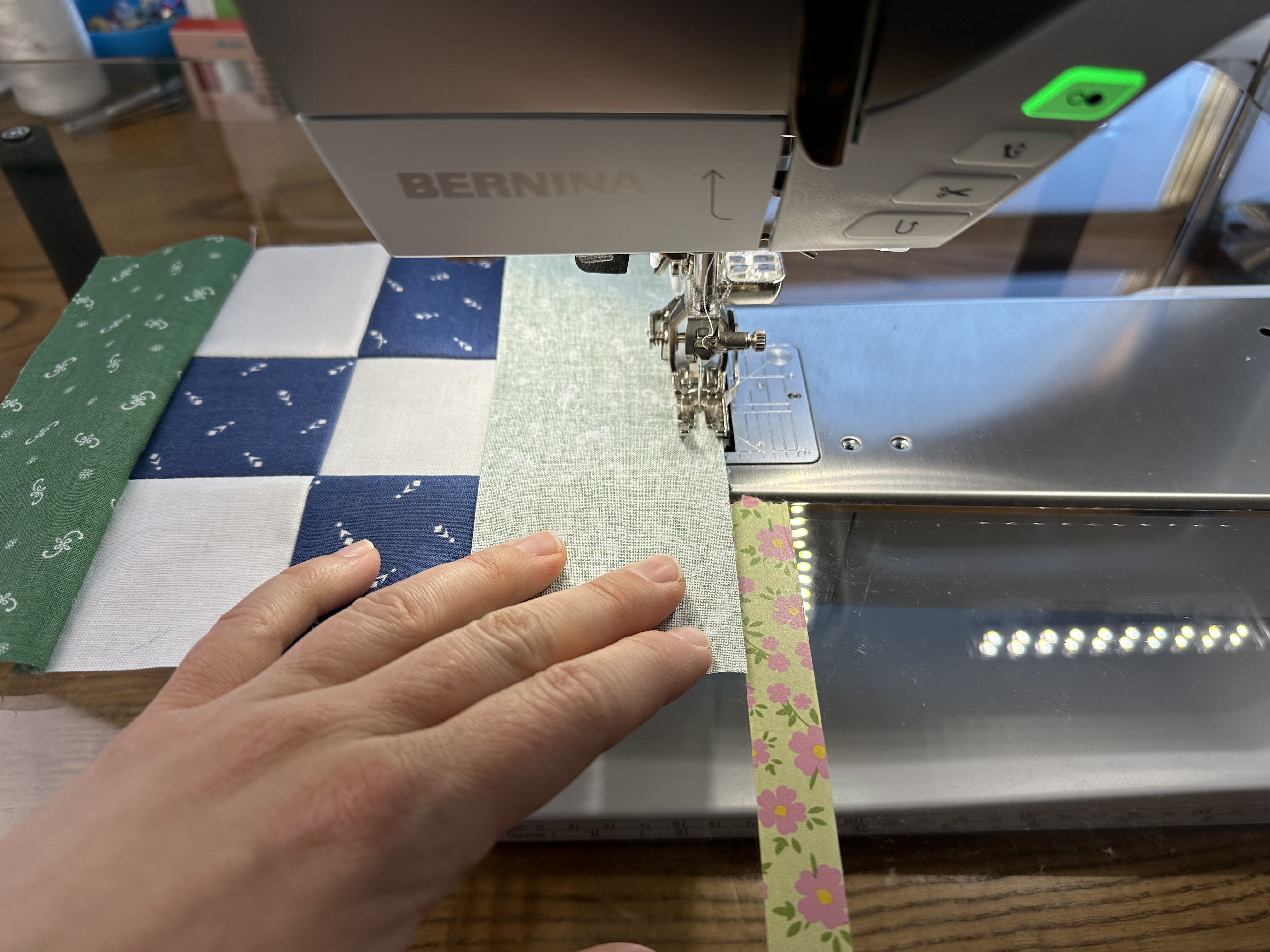 Then, get another 2 1/2” x 6 1/2” pieces of alpine fabric. and place it on top of the white square, right sides together. Sew together with a 1/4" seam allowance.