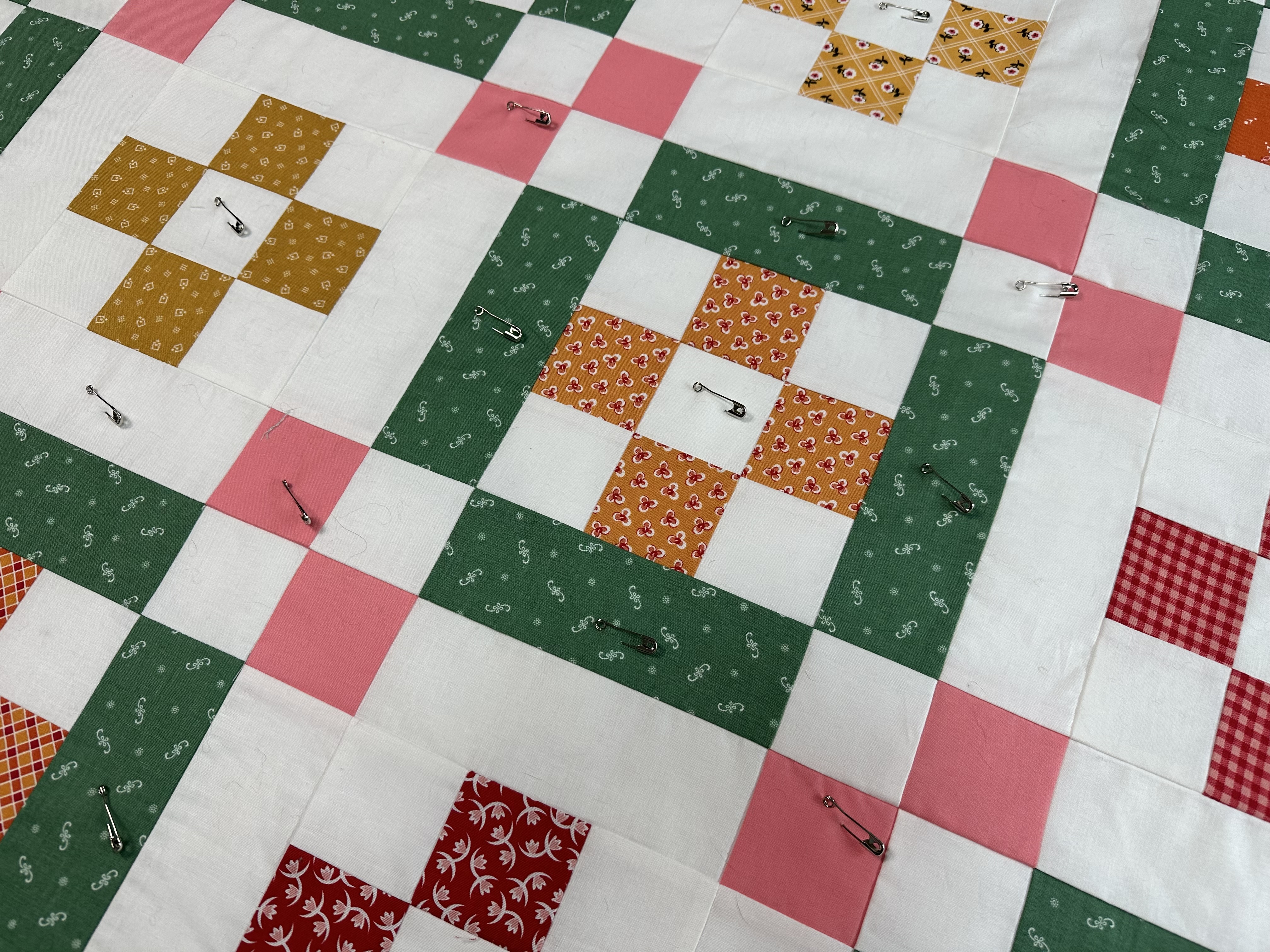 Pin basting the quilt from the Nona Quilt Along BERNINA WeAll Sew blog