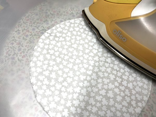Using a silicone sheet on the ironing surface, carefully press center.