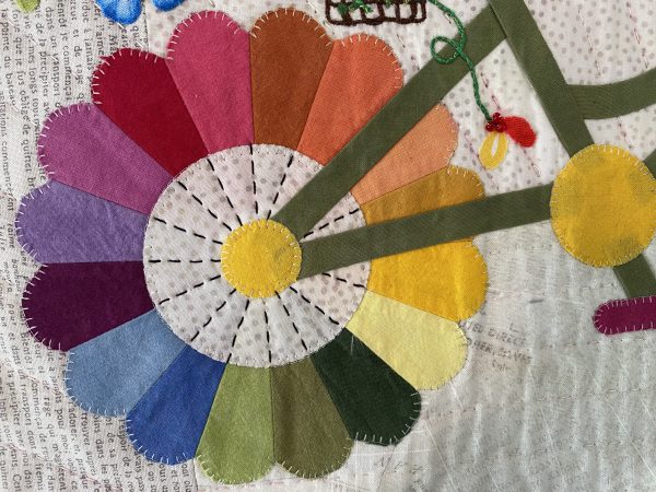 An alternative to the pointed Dresden is the sister block, the curved edge Dresden. The blanket stitched appliqué technique works well on this block as well.