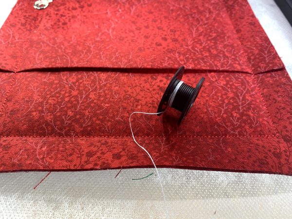 This step displays the beauty of the In The Hoop experience. The back of the mug rug is added while still in the hoop, completing the entire project.