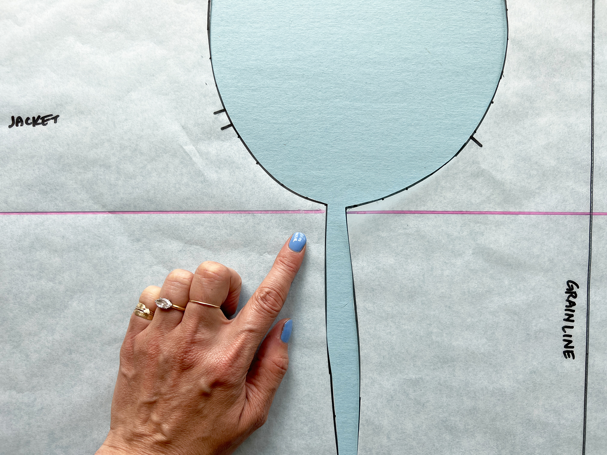 Pink lines are added to help match two sewing pattern pieces at the side seam.