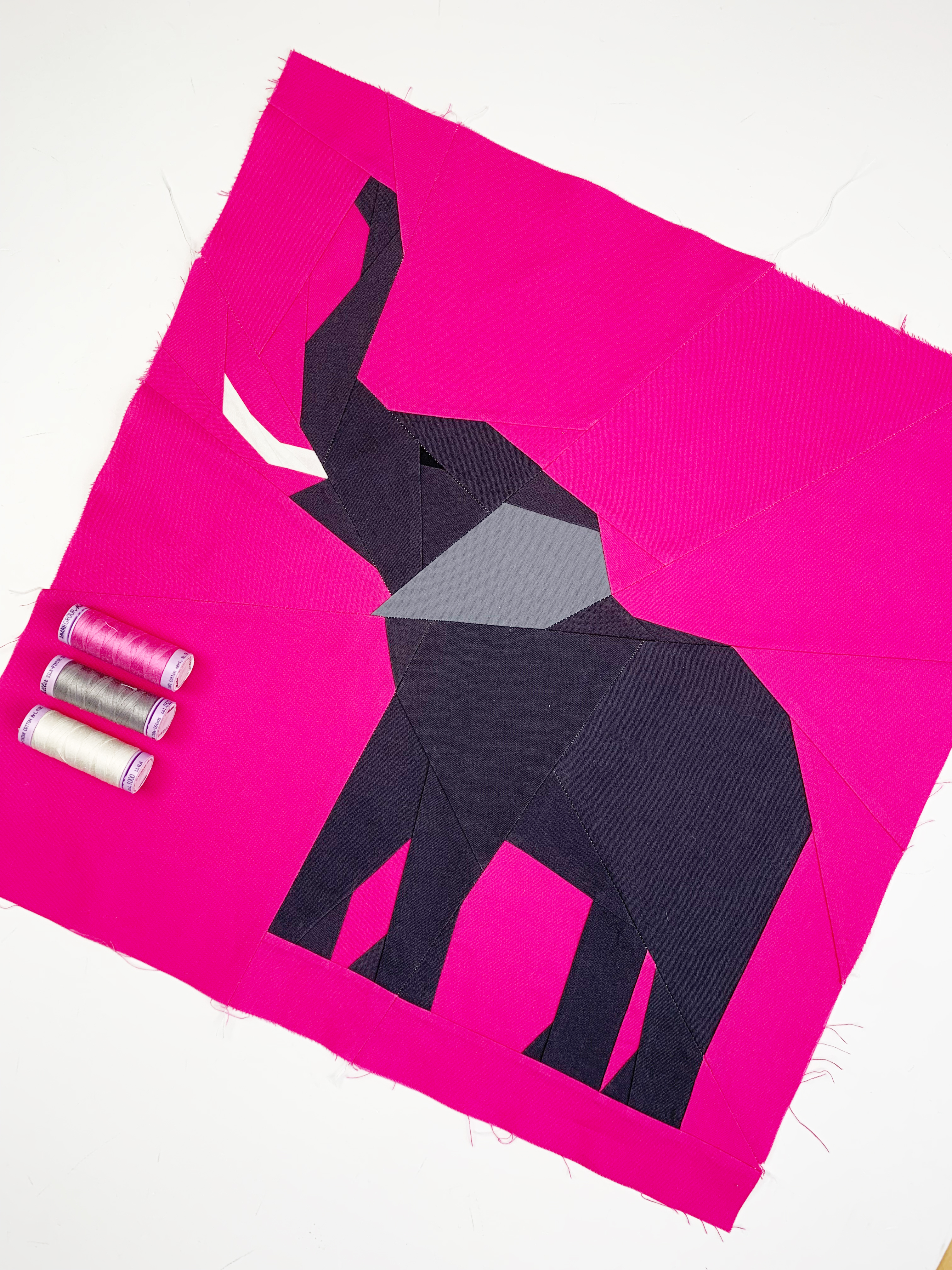 elephant quilt block pattern, charcoal elephant on pink background