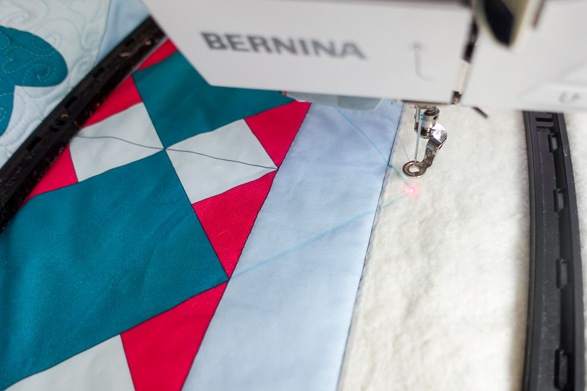Closeup view of the laser centered on the point of the square on the Jump for Joy quilt.