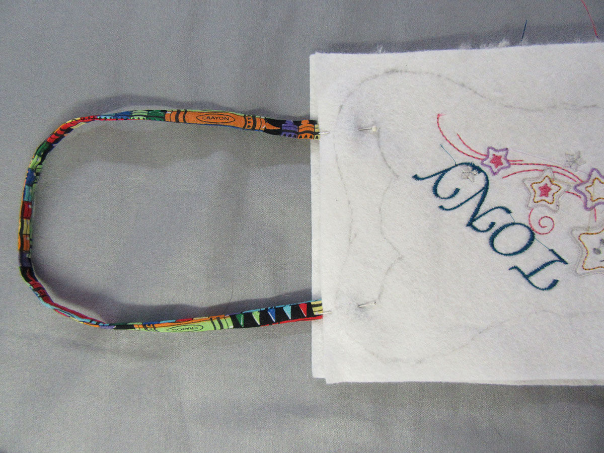 attache handle to tooth fairy bag