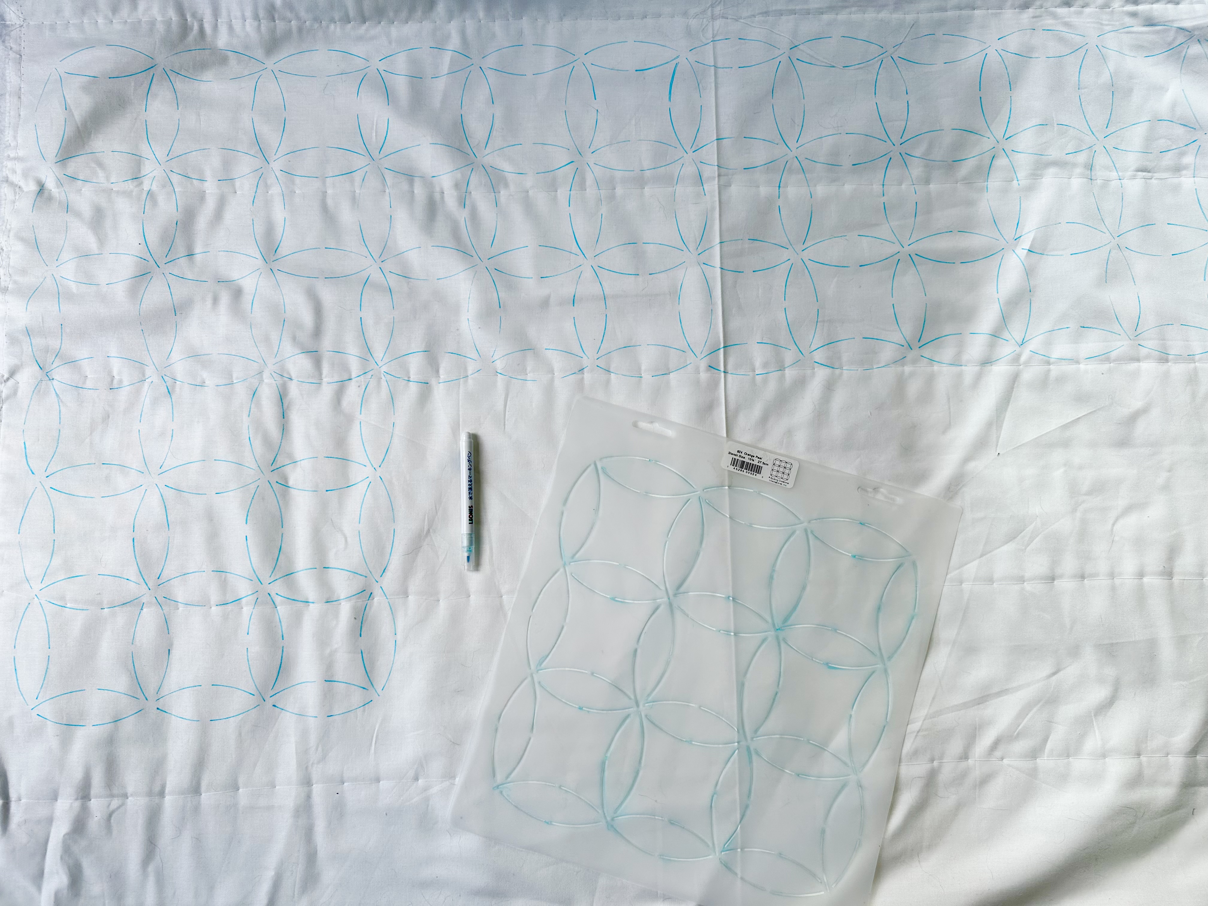 Basted quilt marked for hand quilting