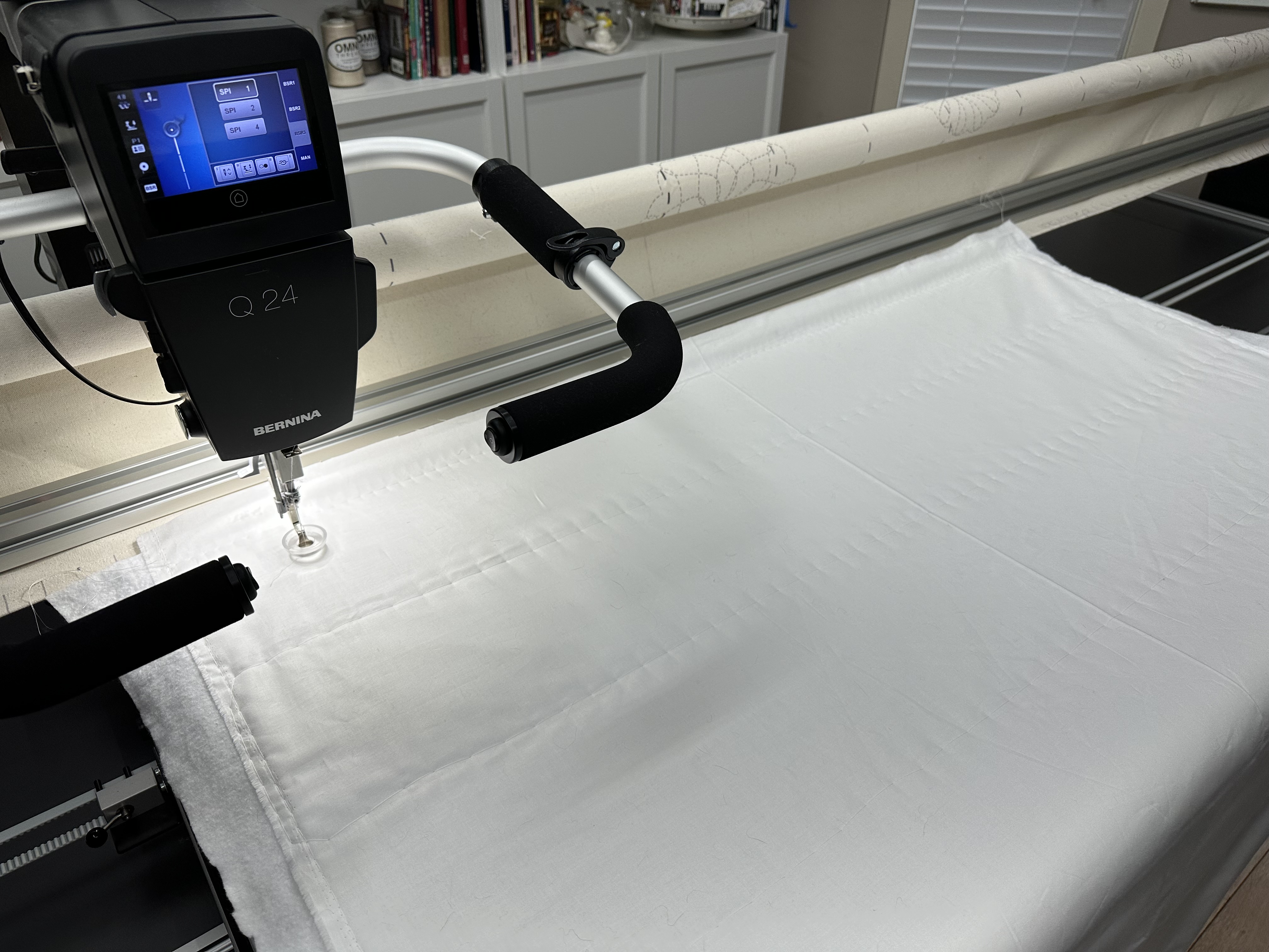 Basted whole cloth white quilt loaded onto the Large PRO frame