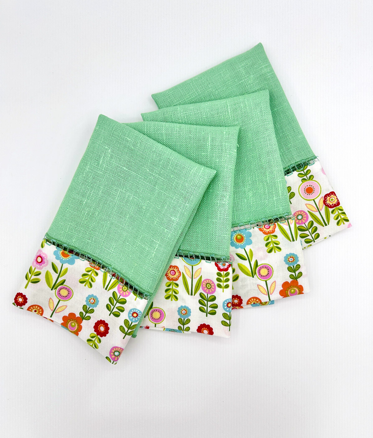 overhead photo of flowered and green fabric upcycled napkins