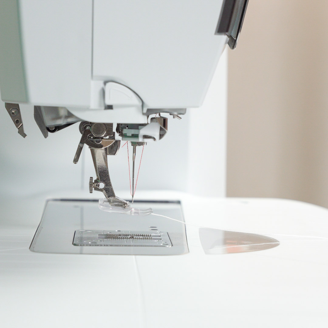 side view of a the BERNINA Clear Embroidery Foot #39C attached with thread