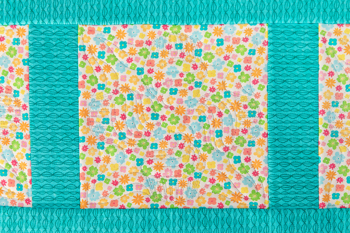 overhead view of embroidery on multi-color fabric
