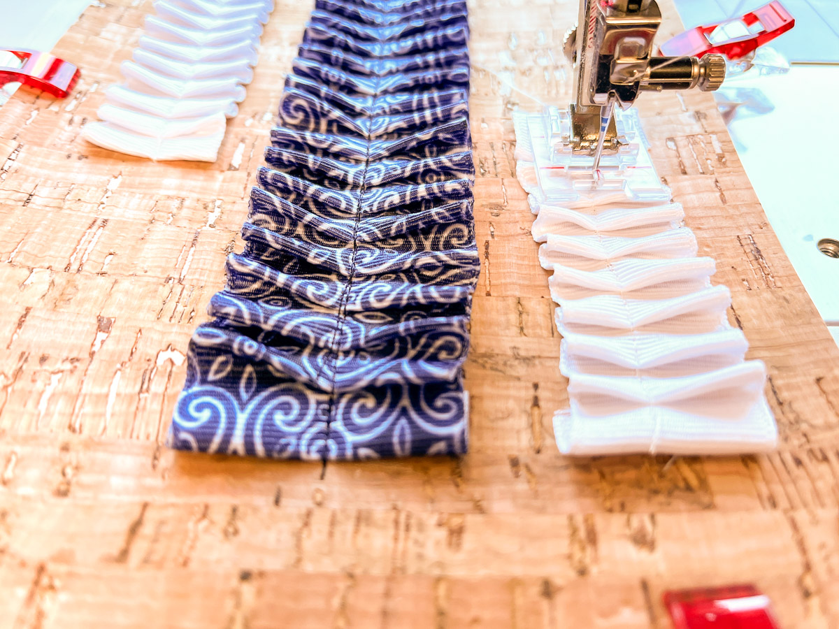Close up view of white ribbon being sewn to cork