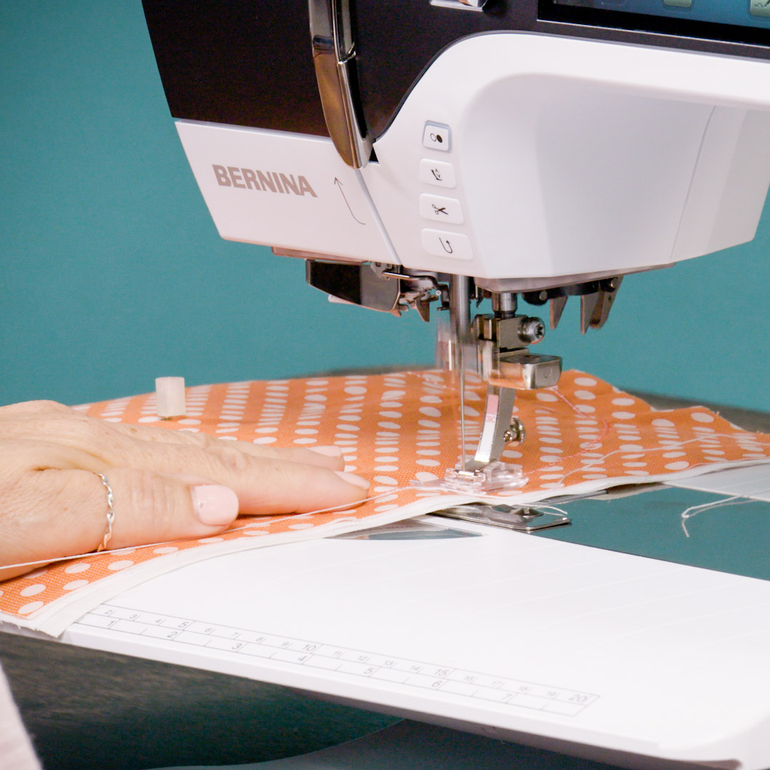 near the end of sewing around a square of orange fabric on the B 790 PRO