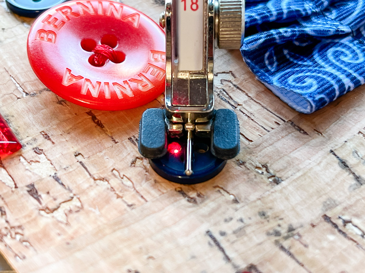 Close up view of the Button Sew-on Foot #18 on cork