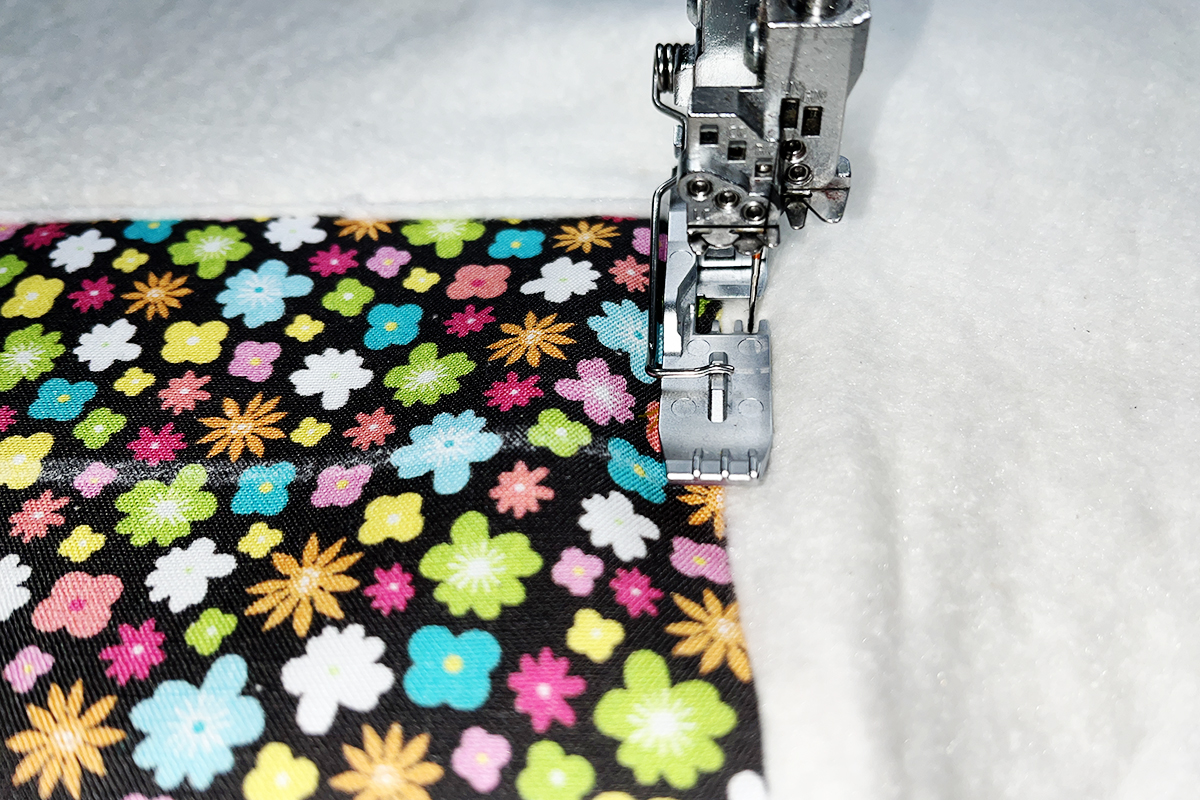 muti-color fabric underneath a presser foot, close up view