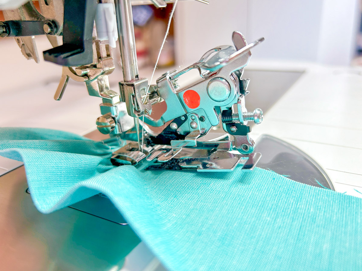 Ruffler foot side view of blue fabric