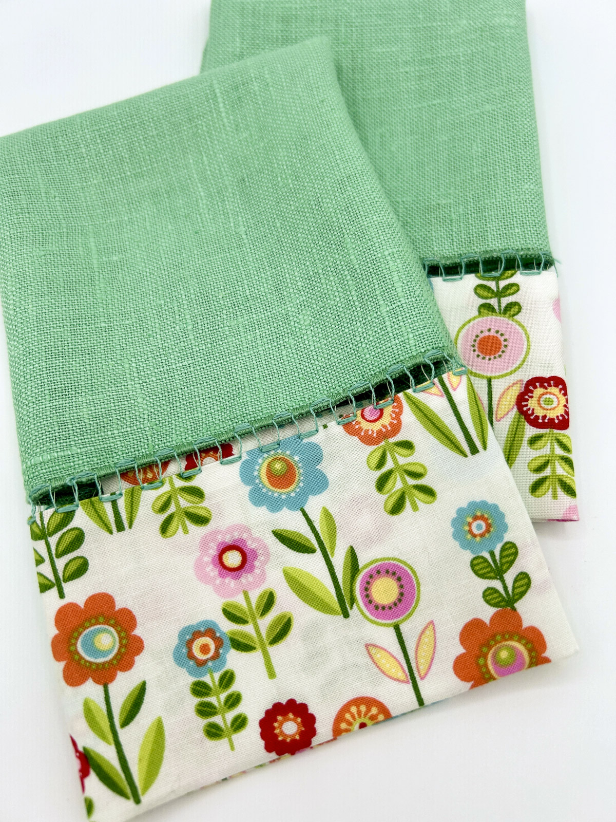 Finished upcycled green napkins with flowered napkins sewn on.