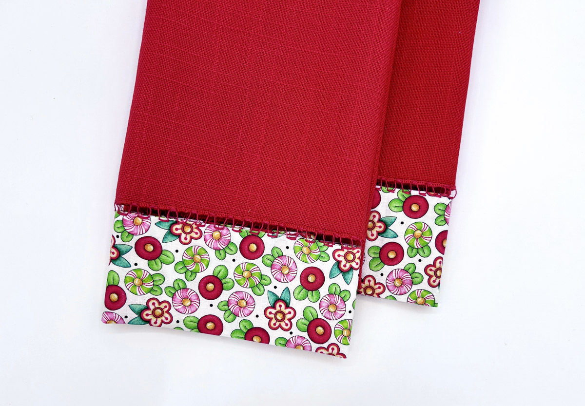 Overhead view of a flowered and red napkin that has been upcycled.