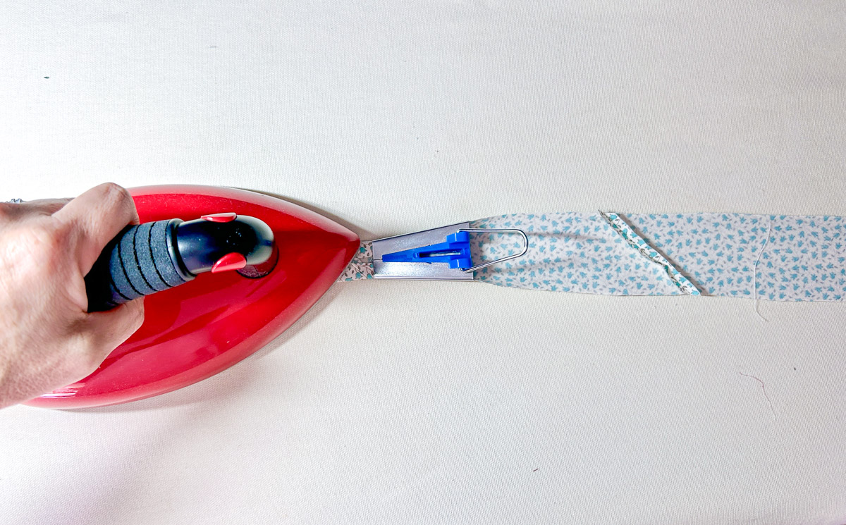 Red ironing bias with tape maker on white background