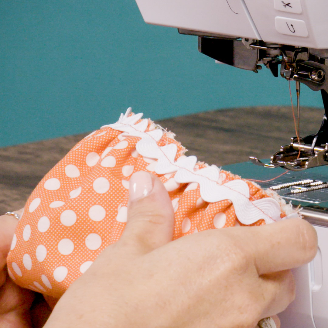 orange polka dot fabric bowl with a closeup view of the rickrack placement