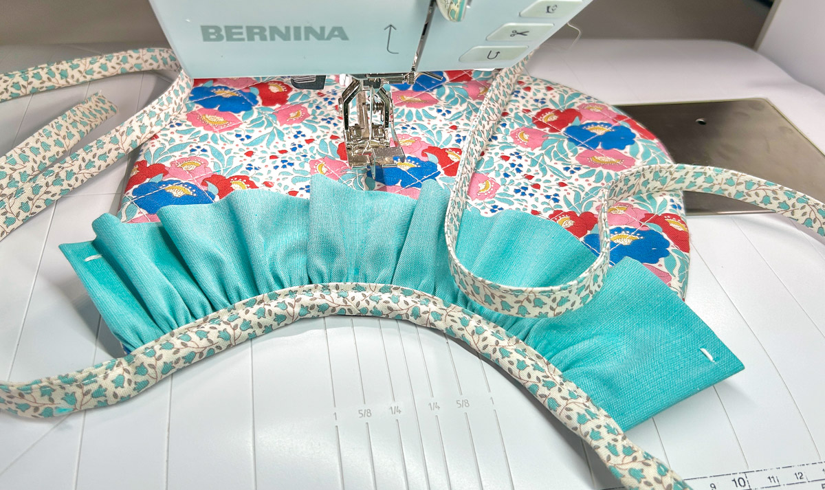 bib, ruffle, and tie all sewn together on top of machine