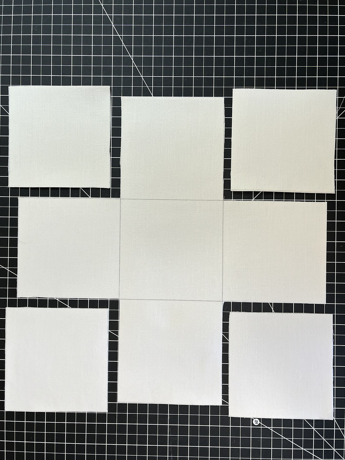 Cut-out vinyl/interfacing square on black cutting mat