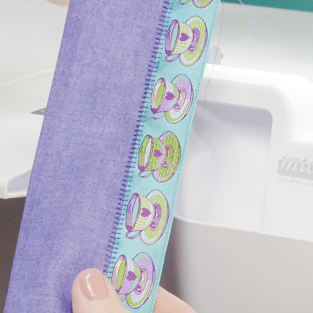 Pulling apart sewn fabrics at the seam to reveal the ladder stitch.