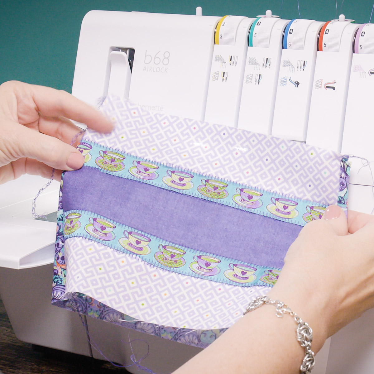 Hands turning the fabric right-side out after seaming.