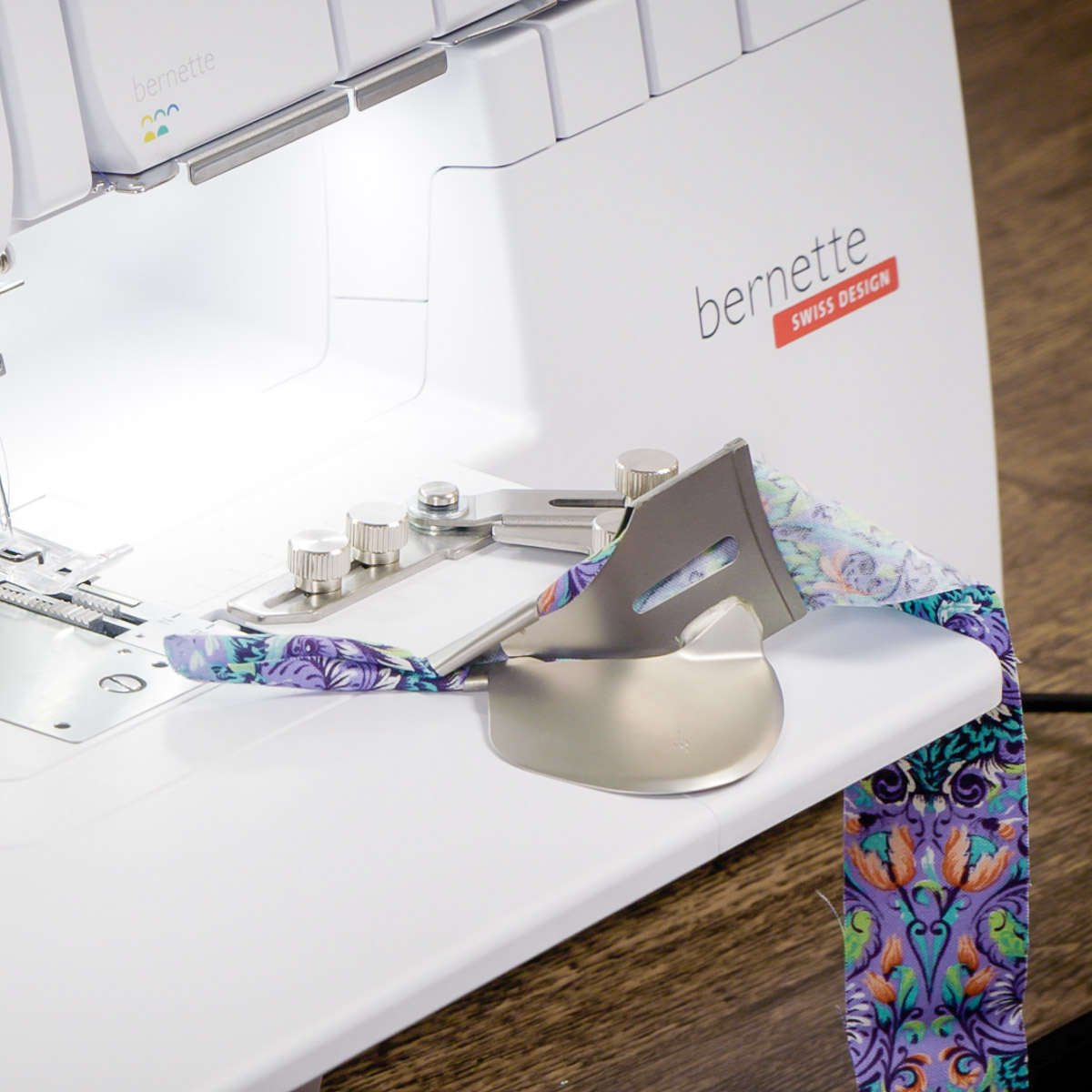 Front view of binding fabric being fed through the binder attachement.
