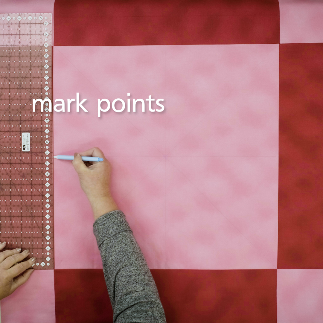 Overhead view of pink and red checkered table topper with points marked