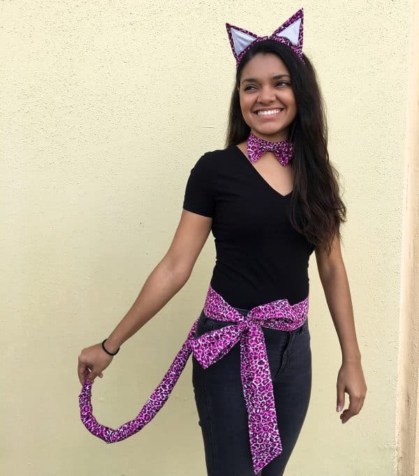 Woman wearing purple-pink cat print ears and tail