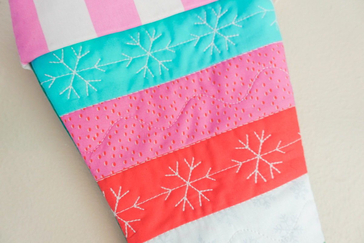 Blue, red, pink, and green quilted stocking close-up