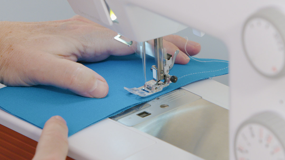 Sewing heavy blue fabric on a bernette sewing machine.